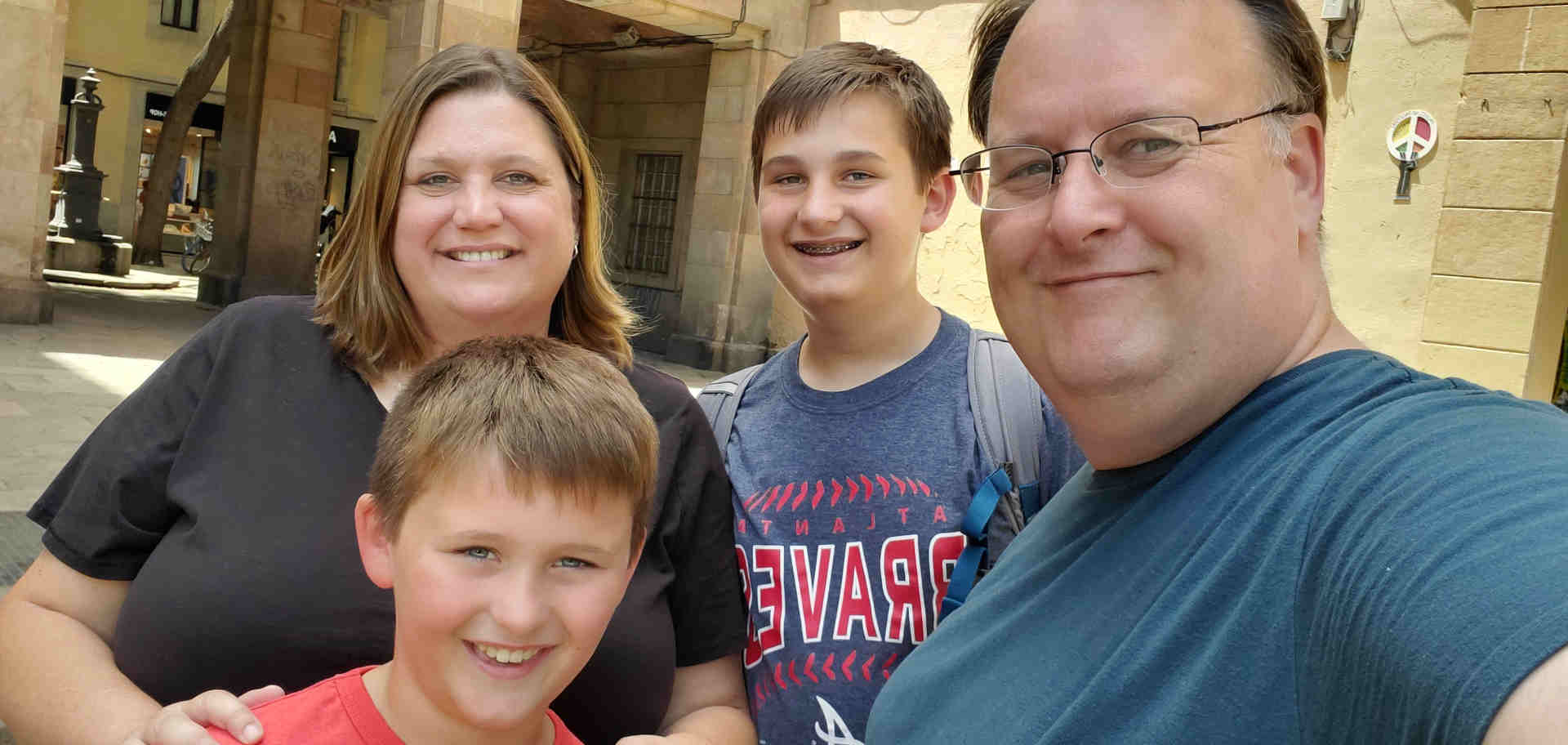 four people in front of a side street